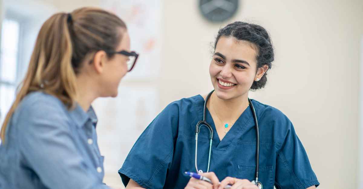 Nurse wearing blue scrubs and a stethoscope around her neck
